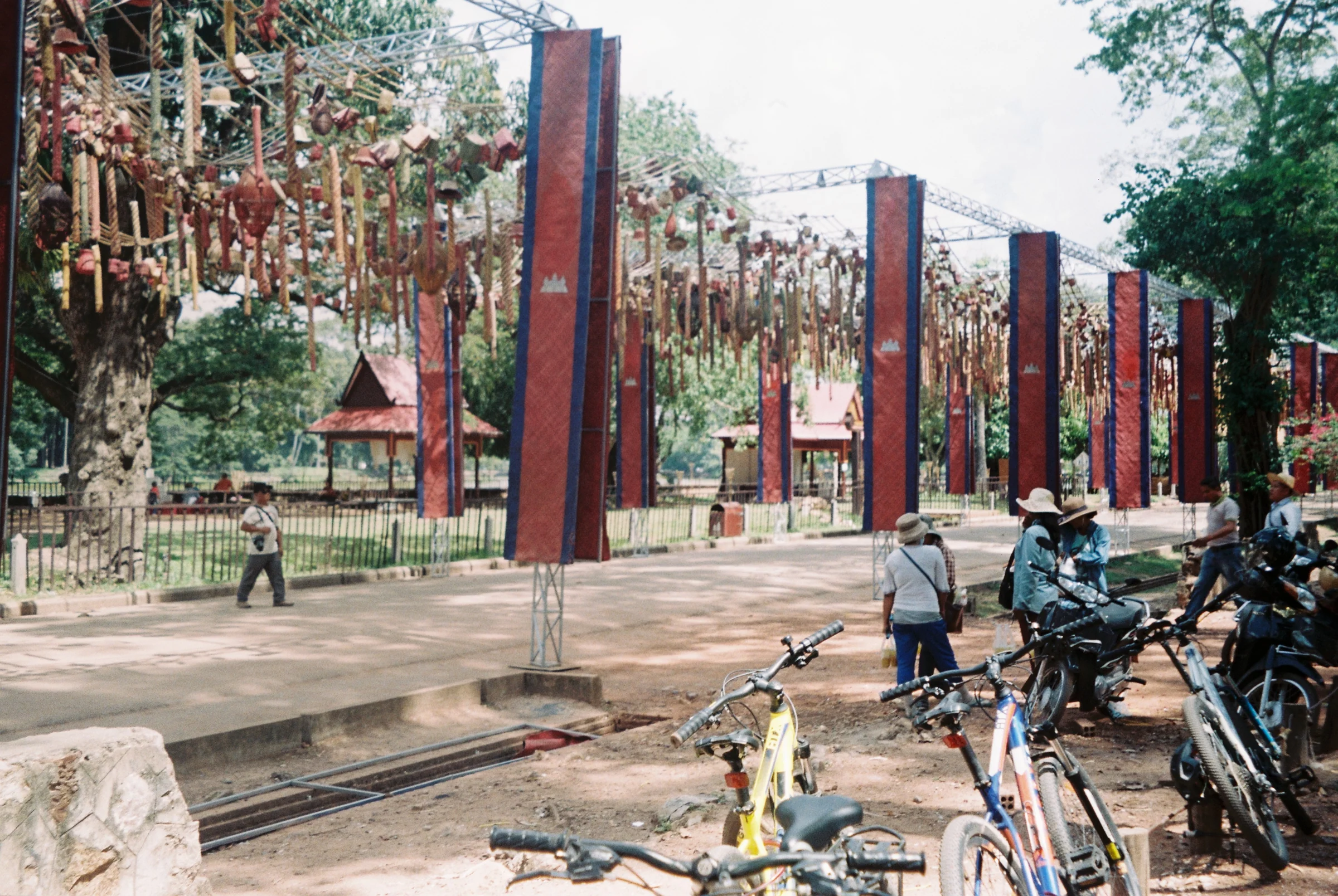 Red columns, bicycles, and a public square in Thailand.